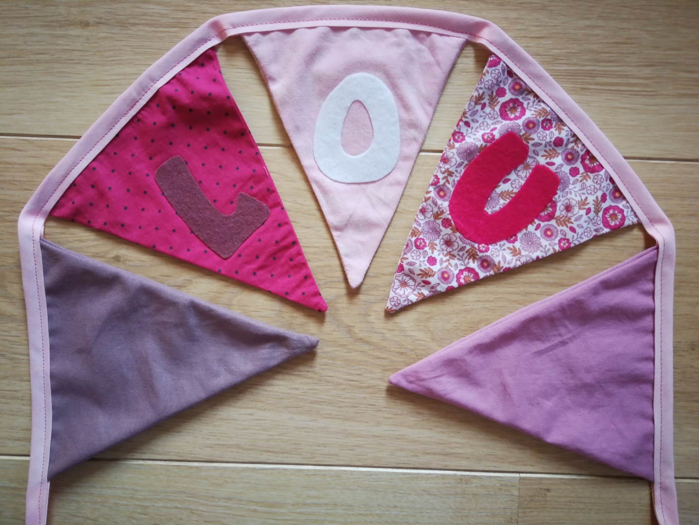 Guirlande de fanions en tissus (fushia, parme, violet foncé et rose) et personnalisable avec prénom